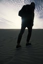 Man with a backpack walking in the desert