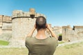 Man taking a picture of the Fort de Salses, France