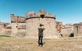 Man taking a picture of the Fort de Salses, France