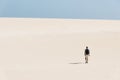 Young backpacker man walking by the desert