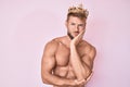 Young caucasian man shirtless wearing king crown thinking looking tired and bored with depression problems with crossed arms