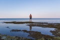 Young caucasian man in shorts, half body naked standing on Croatia sea shore edge. Back view Royalty Free Stock Photo