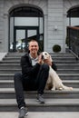 Young man sit hugging golden retriever dog Royalty Free Stock Photo