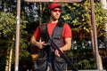 Young man skeet shooting outdoors, shooting clay pigeon targets in outdoor range