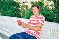 Young caucasian man smiling happy using touchpad and headphones sitting on the bench Royalty Free Stock Photo