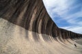 Young caucasian man standing at Wave Rock. Wave Rock Royalty Free Stock Photo