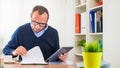 A young caucasian man with tablet in his office.