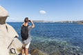 Man taking a photo of the coast in Sardinia, Italy