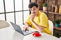 Young caucasian man using laptop drinking coffee at home Royalty Free Stock Photo