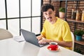 Young caucasian man using laptop drinking coffee at home Royalty Free Stock Photo