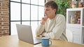 Young caucasian man using laptop sitting on table at dinning room Royalty Free Stock Photo