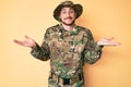 Young caucasian man wearing camouflage army uniform smiling showing both hands open palms, presenting and advertising comparison Royalty Free Stock Photo