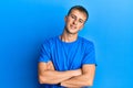 Young caucasian man wearing casual blue t shirt happy face smiling with crossed arms looking at the camera Royalty Free Stock Photo