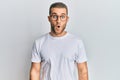 Young caucasian man wearing casual clothes and glasses afraid and shocked with surprise expression, fear and excited face Royalty Free Stock Photo