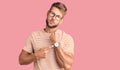 Young caucasian man wearing casual clothes and glasses in hurry pointing to watch time, impatience, looking at the camera with Royalty Free Stock Photo