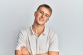 Young caucasian man wearing casual white polo happy face smiling with crossed arms looking at the camera Royalty Free Stock Photo