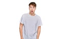 Young caucasian man wearing casual white t shirt afraid and shocked with surprise expression, fear and excited face Royalty Free Stock Photo