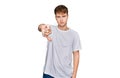 Young caucasian man wearing casual white t shirt looking unhappy and angry showing rejection and negative with thumbs down gesture Royalty Free Stock Photo