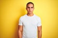 Young caucasian man wearing casual white t-shirt over yellow isolated background depressed and worry for distress, crying angry Royalty Free Stock Photo