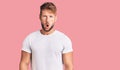 Young caucasian man wearing casual white tshirt afraid and shocked with surprise expression, fear and excited face Royalty Free Stock Photo