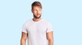 Young caucasian man wearing casual white tshirt smiling looking to the side and staring away thinking Royalty Free Stock Photo