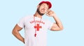 Young caucasian man wearing lifeguard t shirt holding whistle stretching back, tired and relaxed, sleepy and yawning for early Royalty Free Stock Photo