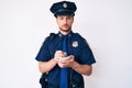 Young caucasian man wearing police uniform writing fine skeptic and nervous, frowning upset because of problem