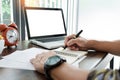 young caucasian man working at home planning work writing note on some project with his laptop on a desk, strartup business, e Royalty Free Stock Photo