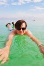 Young caucasian man about 29 years old is swimming when relaxing at the beach of the resort. Sea season summer. Close-up, vertical Royalty Free Stock Photo