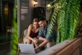 Young caucasian married couple spending time together at home, using laptop for online shopping, web browsing, watching movie Royalty Free Stock Photo