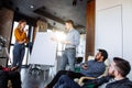 Multi-ethnic people planning business strategy with scheme on flip chart Royalty Free Stock Photo