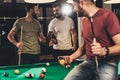 young caucasian men drinking beer beside billiard table Royalty Free Stock Photo