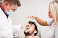 Young Caucasian man having his teeth examined in dental clinic Royalty Free Stock Photo