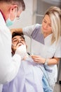 Young Caucasian man having his teeth examined in dental clinic Royalty Free Stock Photo