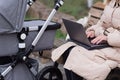 young caucasian mother walking with newborn baby in buggy due to coronavirus covid-19 pandemic lockdown. Business woman Royalty Free Stock Photo