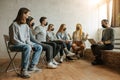 Young people sit together in masks Royalty Free Stock Photo