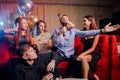 Young caucasian people dance and sing in karaoke club Royalty Free Stock Photo