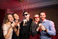 Young caucasian people dance and sing in karaoke club Royalty Free Stock Photo