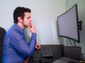 Young caucasian programer man thinking about a work problem Royalty Free Stock Photo