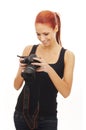 A young Caucasian redhead woman holding a camera Royalty Free Stock Photo