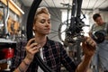 Repairman girl installing bike cassette on wheel