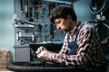 Young caucasian repairman repairing mountain bike wheel in bike shop workshop. Fixing bicycle. Caring for you wheels. man mechanic