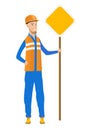 Young caucasian road worker showing road sign.