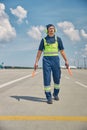 Young Caucasian signalman in headset walking forward