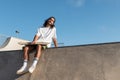 Caucasian skater sitting in the skate park