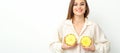 Young Caucasian smiling woman holding slices pineapple over white background, breast health concept. Royalty Free Stock Photo