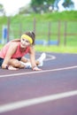 Young Caucasian Sporstwoman Having Stretching Exercises On Stadium