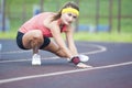 Young Caucasian Sporstwoman Having Stretching Exercises On Stadium Outdoors