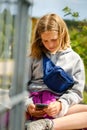 Young girl sitting down looking at mobile phone