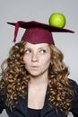 Young caucasian student with an apple on her head Royalty Free Stock Photo